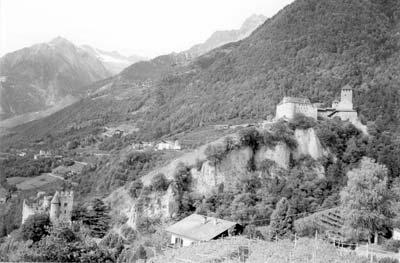 Brunnenburg Castle at lower left and Tirol Castel at upper right on the slopes above Merano, Italy. Photo: Pehrson