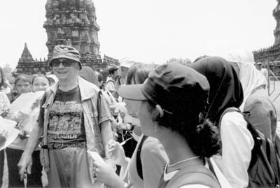 Students at Prambanan on Java surround I.F. Harder and interview him about America.