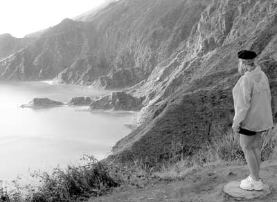 A hiker overlooks the crater of Seven Cities on the island of San Miguel.