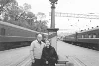 Merle and Marie Crow in Vladivostok. The mile marker behind them shows the distance to Moscow in kilometers. 