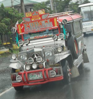 Jeepneys, locally manufactured pickups with canopied bench seats and brightly colored galvanized aluminum bodies, serve as cheap transport at around 16 cents for a 7-kilometer ride.