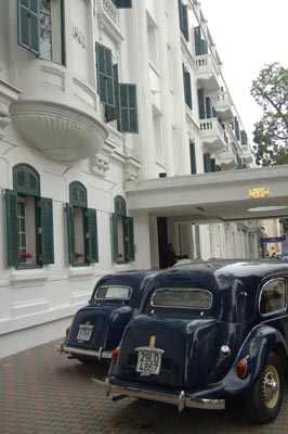 1950s Citroën autos sit outside the Metropole Hotel in Hanoi.