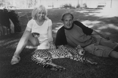 Judy and Ron Strampe with a sleepy cheetah. 