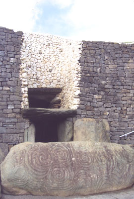 Entrance to Newgrange, with the huge stone incised with spirals lying in front.