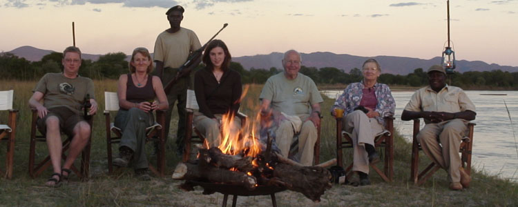 The three of us, plus our guide, driver and guard and two employees of Kapamba bush camp (left), stop for drinks during our evening safari.