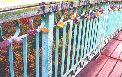 : Locks painted with names on the moon bridge in Cherkassy, Ukraine. 