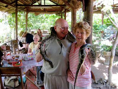 Following a cruise on the Mekong Delta, the Morrises were introduced to this boa constrictor at their lunch stop.