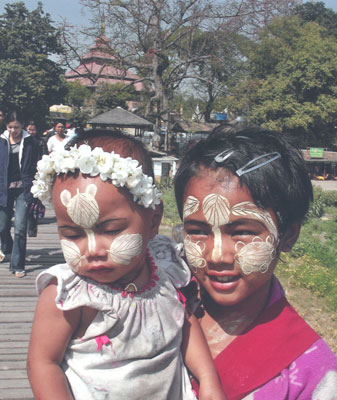 Woman and child with faces decorated — Mandalay.