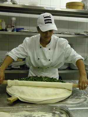 Snjezana Matijas rolls the top layer of dough over the Swiss chard. 