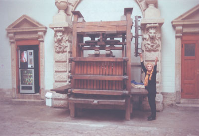 JoAnn Kofoed beside an antique wine press in Beaune. Photo: Bill Kofoed