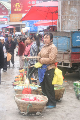 In baskets on each end of a pole, fruits and vegetables were being sold in the market in Guiyang. Photo: Bruck
