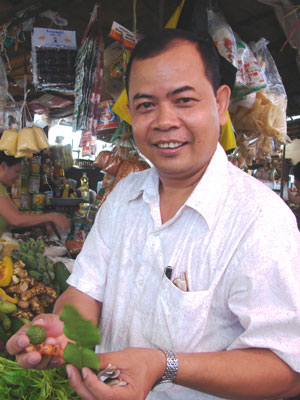 At a wet market in Phnom Penh, chef San Sinith explained the qualities of various herbs. Photo: Sandra Scott