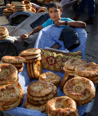 Bread seller at the Andijon market, Uzbekistan.