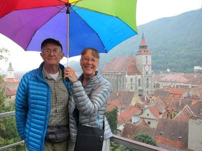 Fred and Ann Abeles on the balcony of the Black Tower with a view of Brașov, Romania, below.