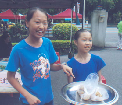 Girls selling food at the Holy Family Catholic Church yard sale — Taipei. Photo by Kevin O’Brien