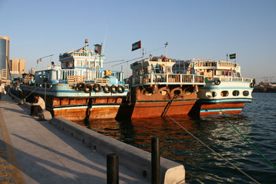 Large, colorful transport barges docked in Dubai Creek.