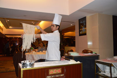 At Peking Garden Restaurant, a chef entertains diners by making perfect noodles by hand.