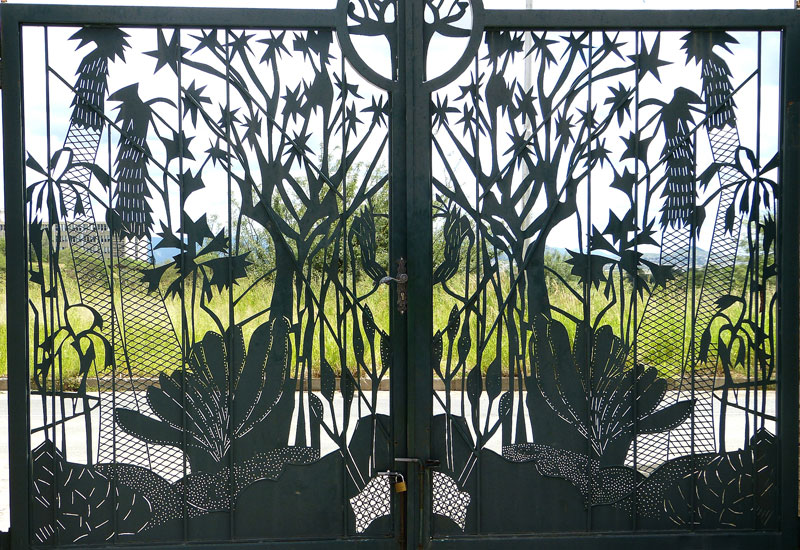  At the entrance to the National Botanic Garden, the wrought-iron gate depicts plants indigenous to Namibia — Windhoek. Below: Silke Rügheimer, the garden’s director/curator. Photos by Yvonne Michie Horn