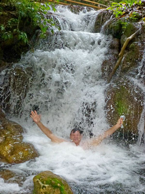Randy enjoying a waterfall massage in a swimming hole at Estância Mimosa in Bonito.