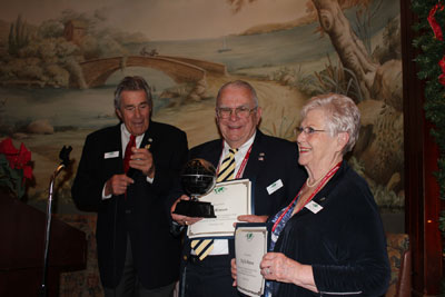 Bob and Phyllis Henson receive their certificates for visiting all of the 324 destinations recognized by the Travelers’ Century Club, presented by the club’s chairman, Klaus Bella (left).