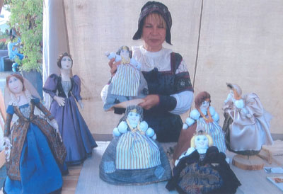 Woman selling dolls in traditional Lithuanian costume — Bartholomew Fair, Vilnius. Photos by Helen Harper