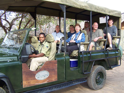 An open safari vehicle used in Tanzania’s southern parks, with Mary and Joseph Lambert in the front row of seats.