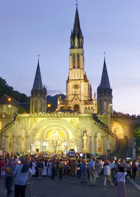 The Sanctuary of our Lady of Lourdes lights the night sky with hope for procession attendees. Photos by Randy Keck<br />
