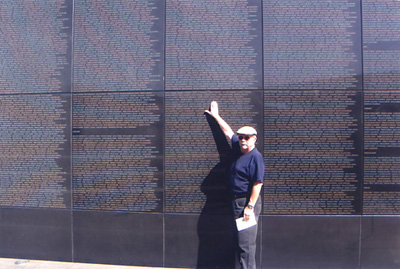 Wayne Buxton pointing out the name of his friend Fred Harrison at the Wall of Remembrance in the UN Memorial Cemetery in Busan. Photo by Janice Buxton