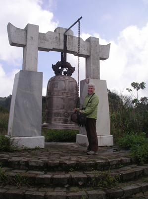 Jean Sargent next to a gong on a mountaintop in Bach Ma National Park, Vietnam. Photo by Jack Sargent