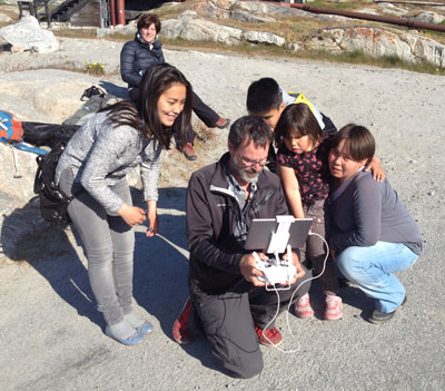 Sarto showing his drone to a family in Nars­arsuaq.