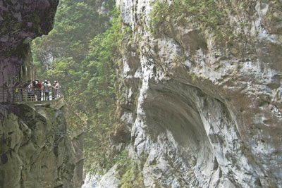 Visitors gather along the road carved into the cliffs of Taroko Gorge.