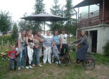 Mary Anne Christie (center) with Stasia (on bike) and her family at their home i