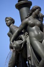 Cast in bronze, with a marble base, the Three Graces fountain (1869) in Place de la Bourse, Bordeaux, France, depicts Zeus’ daughters Aglaea (Splendor), Euphrosyne (Mirth) and Thalia (Good Cheer).