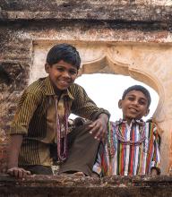 Indian “hotel boys” showed off their climbing skills while wearing my necklace gifts. Photo by Donna Judd