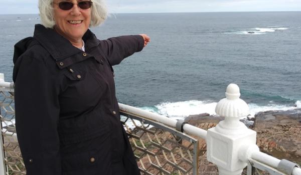 Pointing to a rock that marks the dividing line between the Southern and Indian oceans at the top of the Cape Leeuwin Lighthouse. Photo by Pat Hines