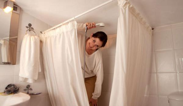 Wielding a handheld shower in a tight shower space lacking a soap dish or shelf may lead to some bathroom gymnastics. Photo by Dominic Bonuccelli