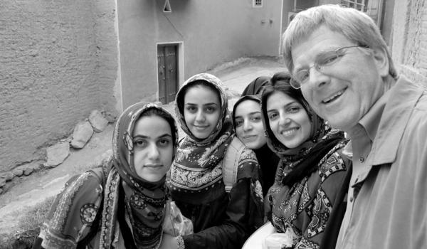 Rick Steves poses with teenage girls in Iran, a place that might give many Americans culture shock.