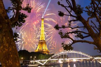 The Bastille Day celebration culminates with a fireworks show at the Eiffel Tower, where France’s national anthem rings through the Champ de Mars.