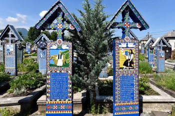 Romania's colorful Merry Cemetery celebrates its dead with poetry and stylized portraits. Photo by Cameron Hewitt