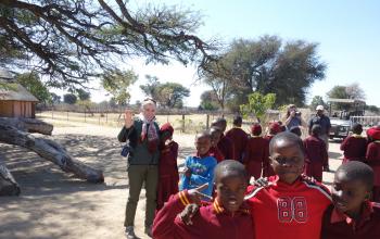 The author with smiling schoolchildren in Mfuwe.