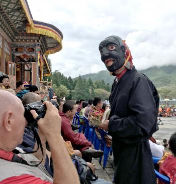 A “clown” depicting the worst of human nature soliciting tips at the Wangduephodrang Tsechu festival.