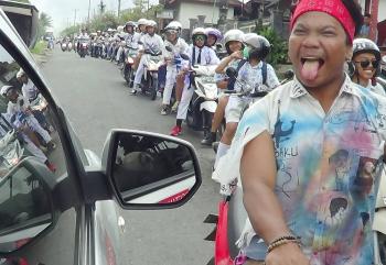 On graduation day in Bali, students on motorcycles took to the road in droves and ceremoniously paraded through the streets.