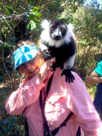 Libby Cagle with a lemur on her shoulder, at Varuna Resort in Madagascar. Photo by Roger McDaniels