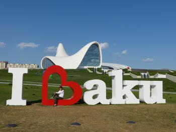 Yvonne Horn poses inside the heart of the “I love Baku” sign in front of Baku’s Cultural Center.