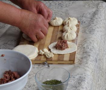 Making khinkali dumplings, which must be eaten with care to avoid spilling the juices inside.