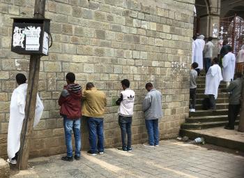 Worshipers praying at the wall of an Ethiopian Orthodox church in Addis Ababa.