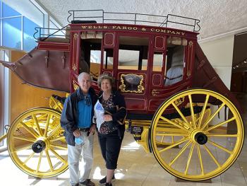 Bill and Liz Fischer next to a Wells Fargo stagecoach — Oklahoma City.