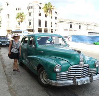 Vicky Hagan and a classic car in Havana. Photo by Mark Hagan
