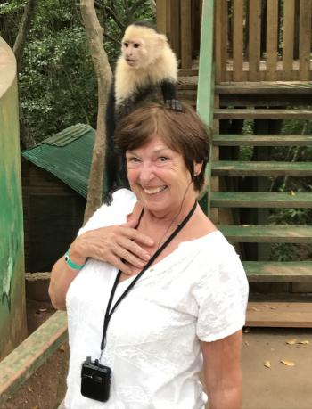 Donna with a tame white-faced capuchin at Maya Eden Eco Park.