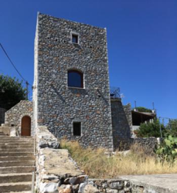 A tower-house in Kokkala, Greece, with steps leading to a small bay. Photos by Linda Huetinck